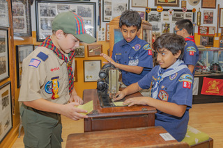 Scouts playing with an old Singer Sewing Machine